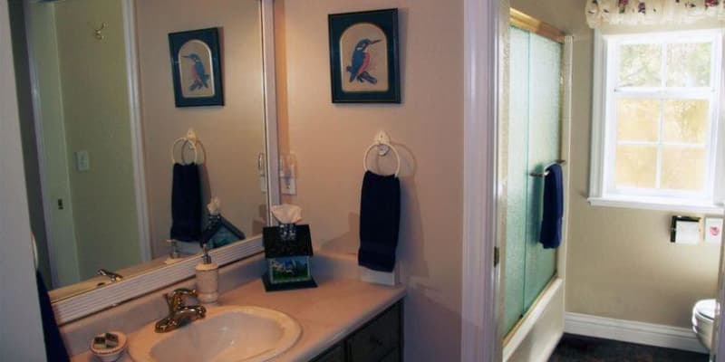 Bathroom with mirror, sink and tub/shower combination