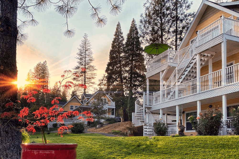 The building's yellow exterior, white trim, and multiple balconies are consistent with the inn's architectural style.